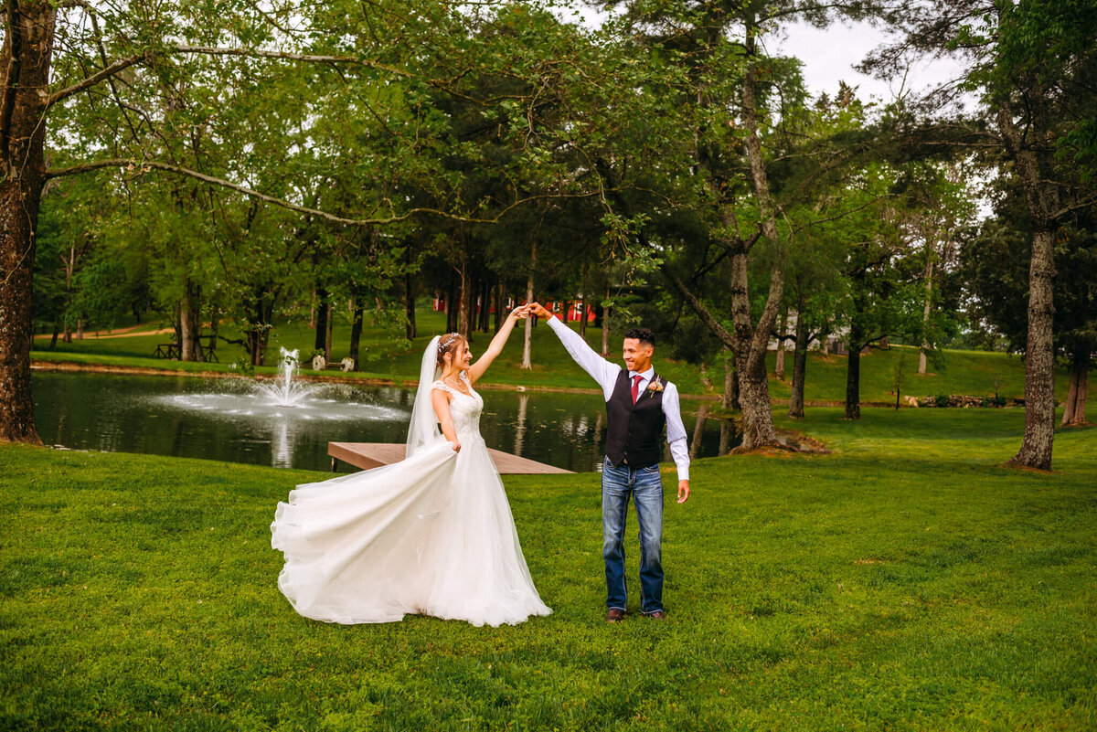 photo of a bride and groom dancing in front of a fountain pond during their Tennessee wedding