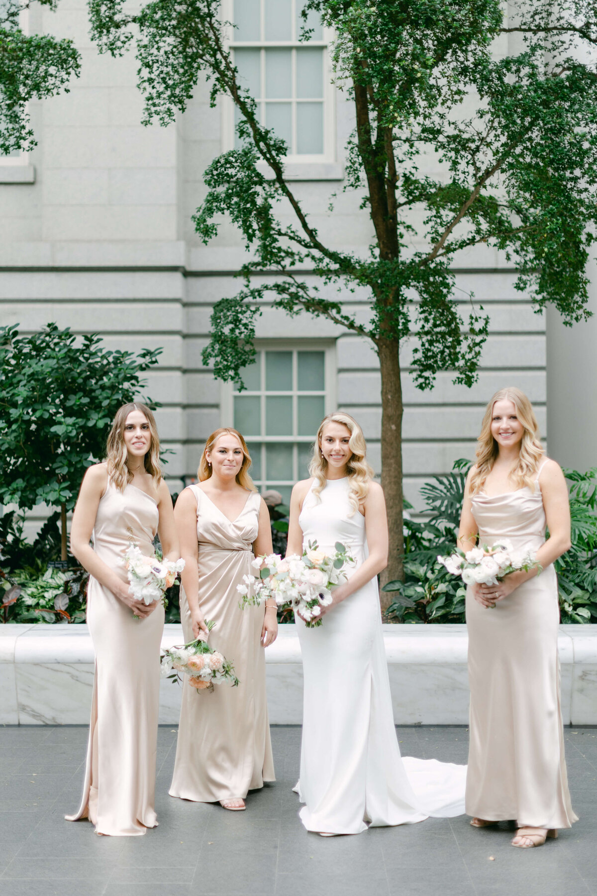A bride stands with her bridesmaids.