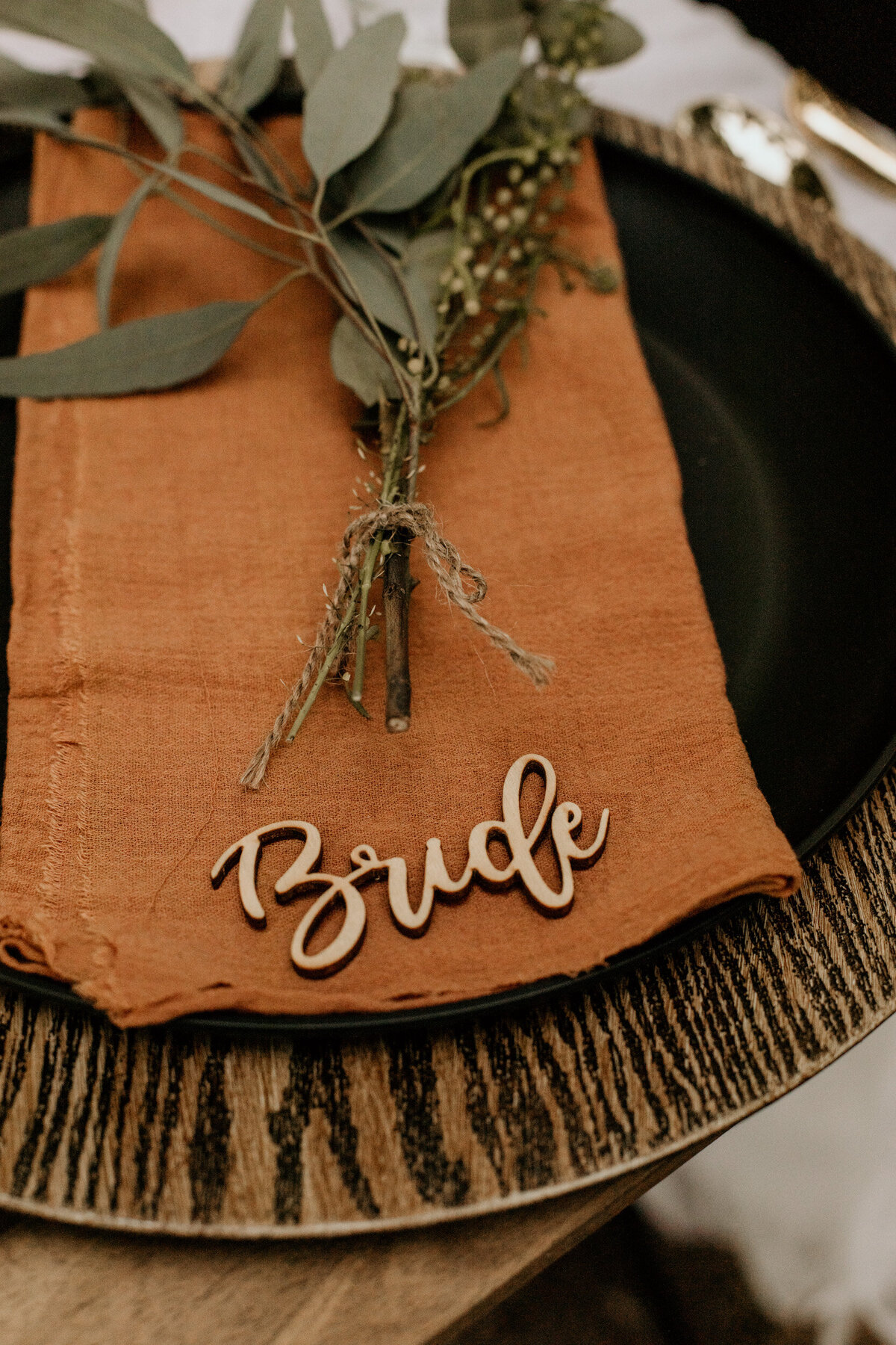 intimate wedding place setting with wooden bride sign