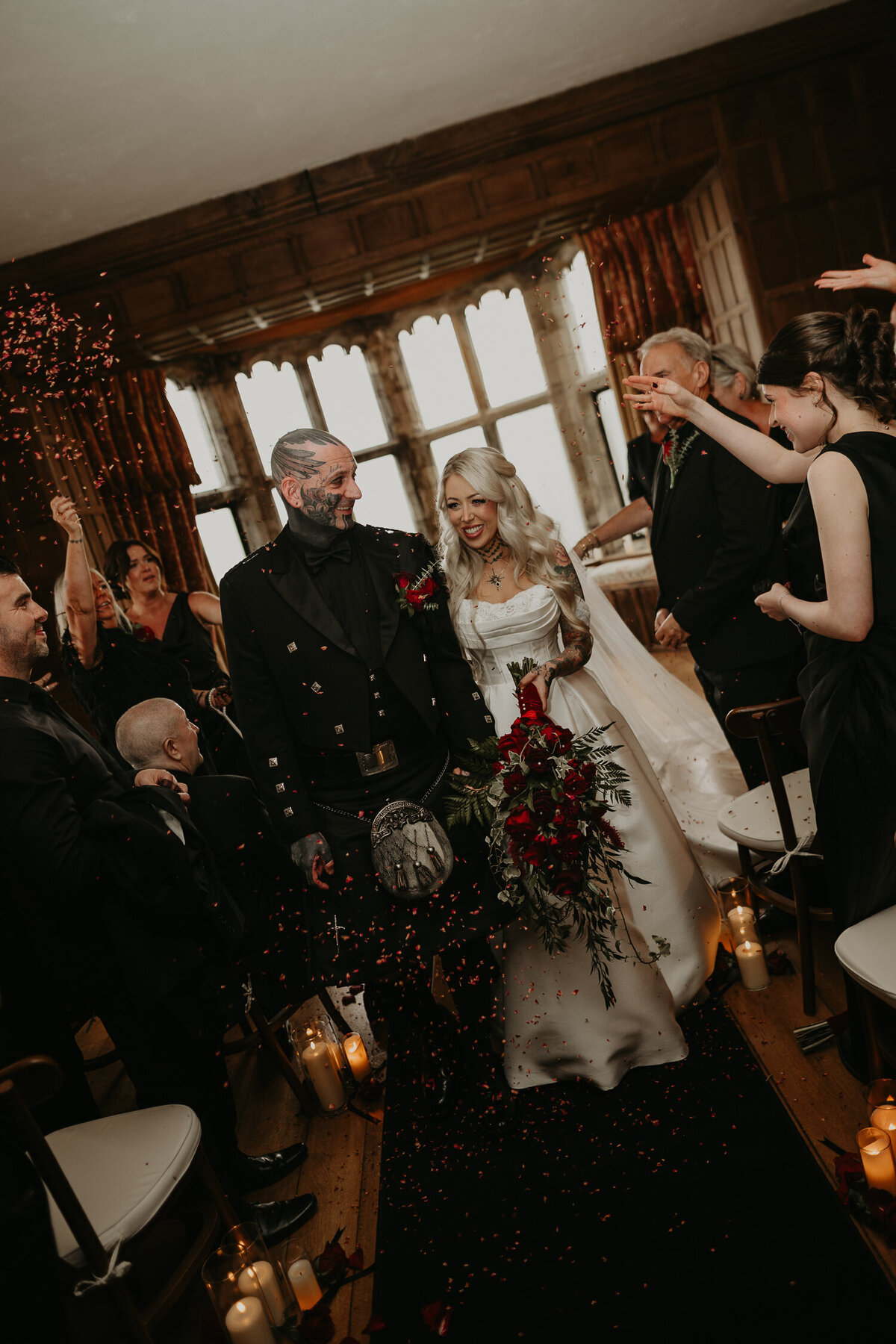 Tattooed Bride and Groom walk back up the aisle after their wedding ceremony at Lympne Castle in Kent.