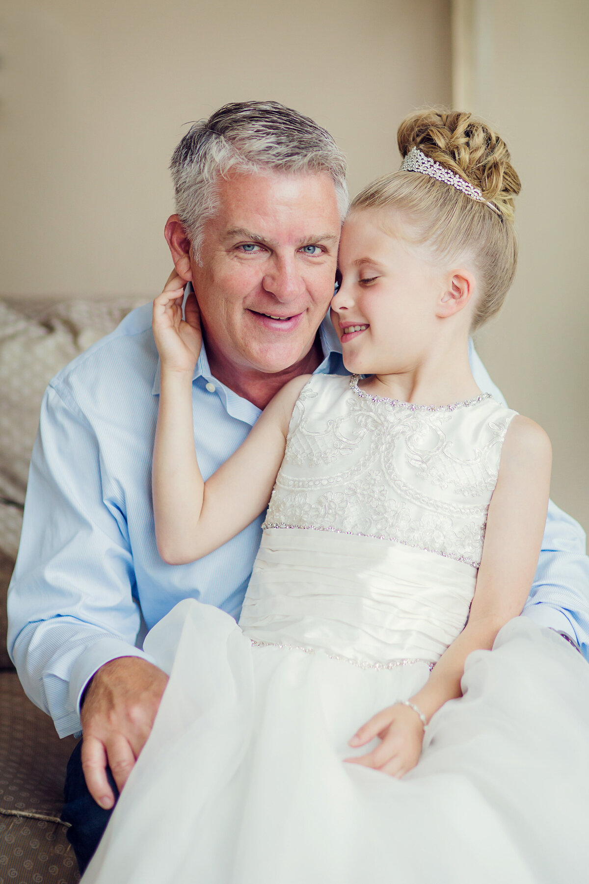 Communion Day for Kiley, and she is snuggling into Dad,. They are both dressed up.