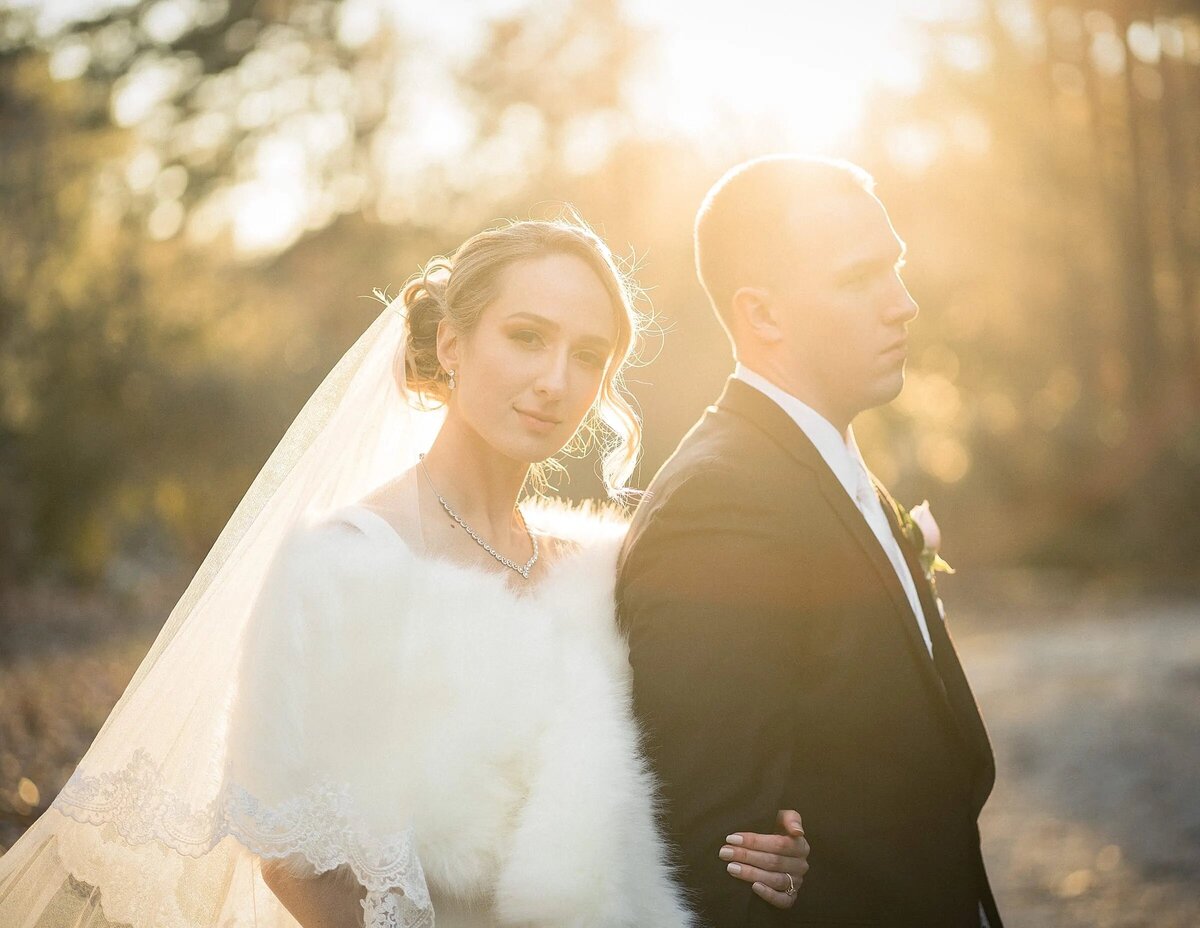 A bride and groom bathed in the golden light of sunset