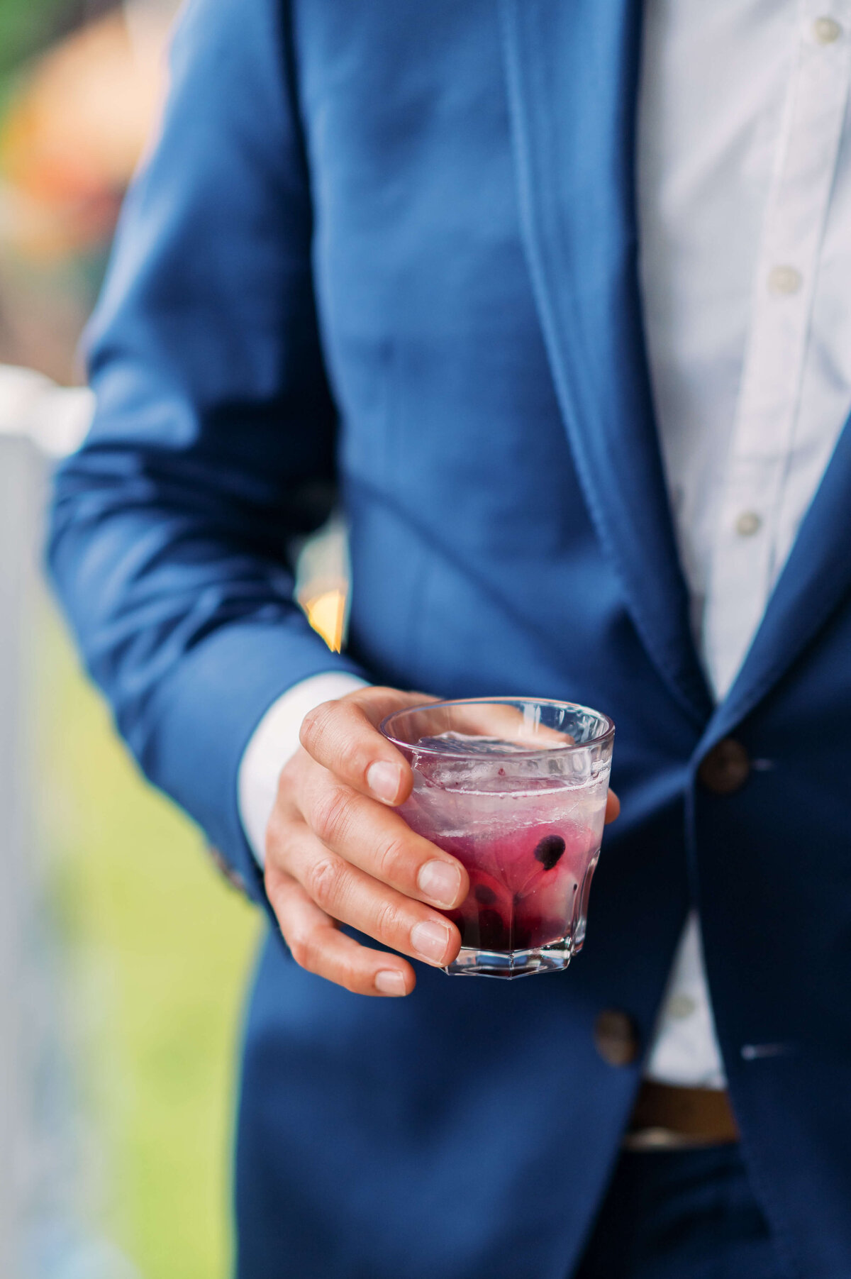 Groom holding a wedding cocktail at Oceanstone Resort Wedding in Nova Scotia
