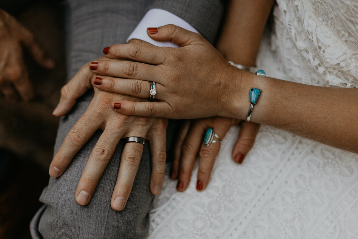 bride and grooms hands together with southwest jewelry