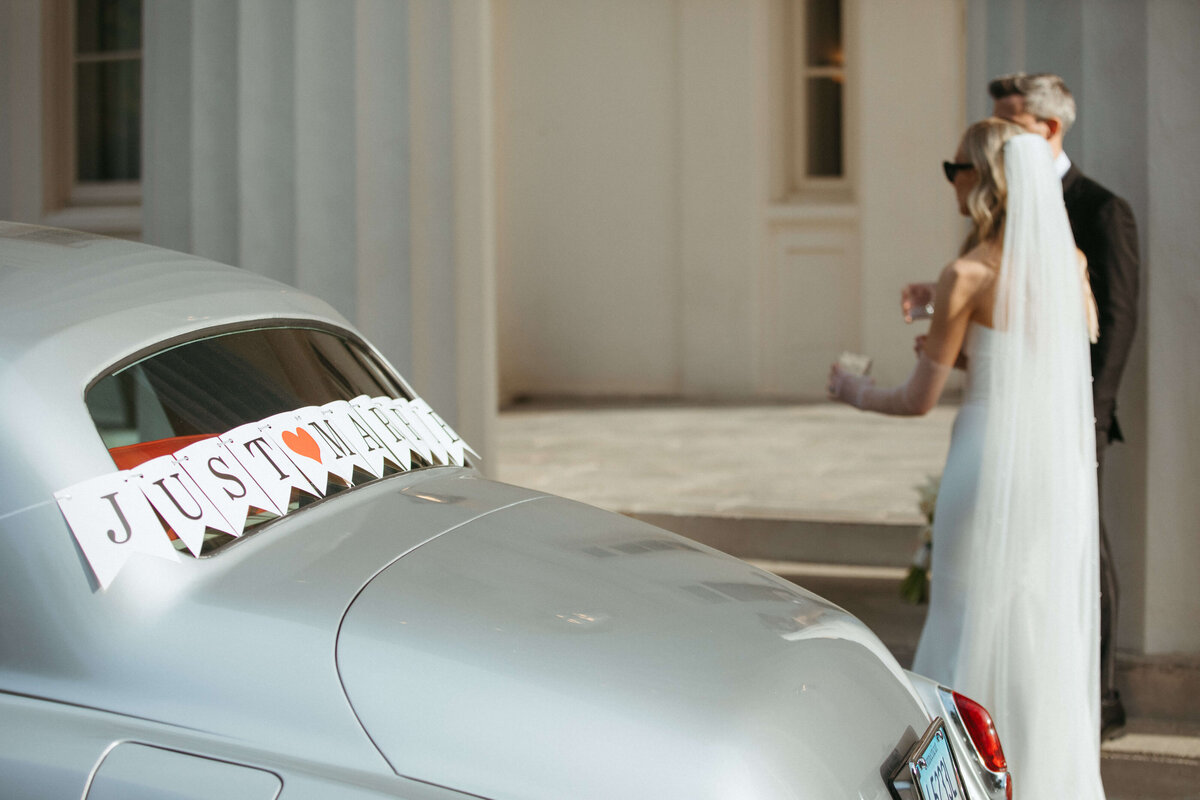 Bride and groom and vintage car