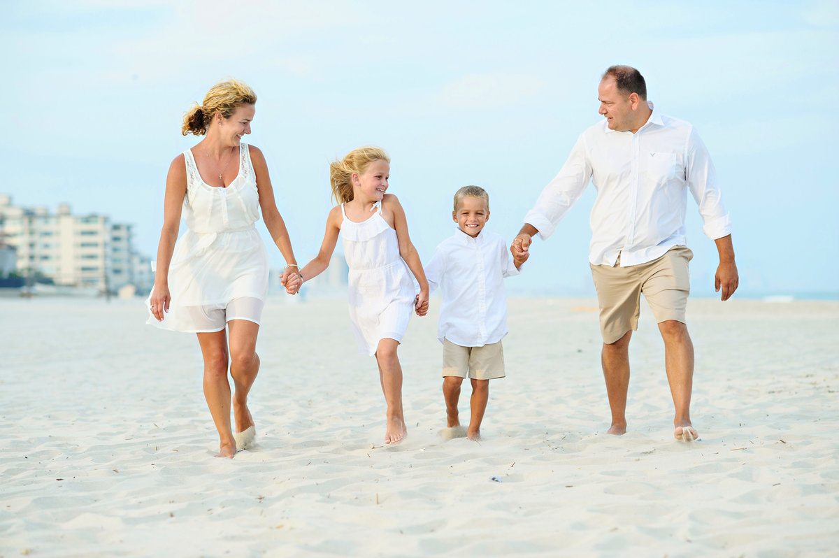 A family runs on the beach in long beach island, NJ.