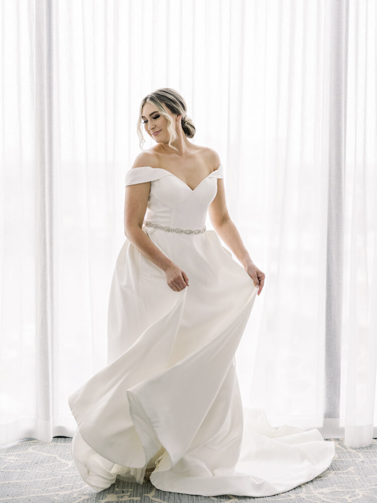 bride twirling in a white wedding dress