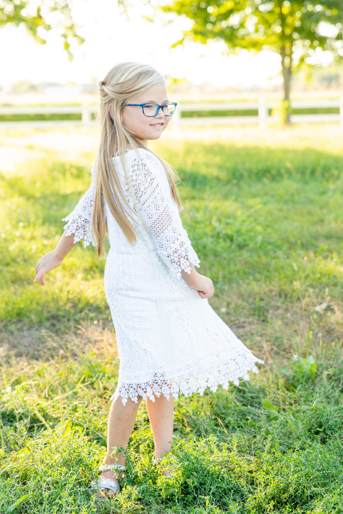 Child twirling in white dress