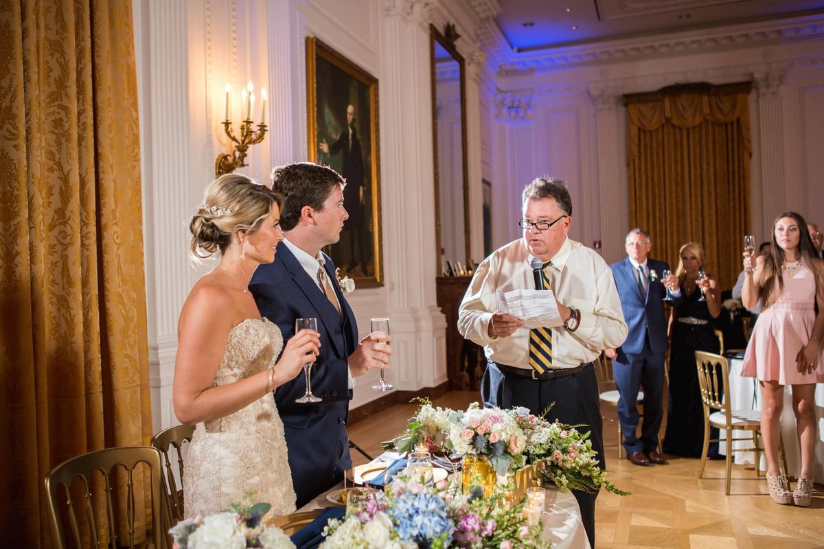 Bride and Groom stand as they accept their toast