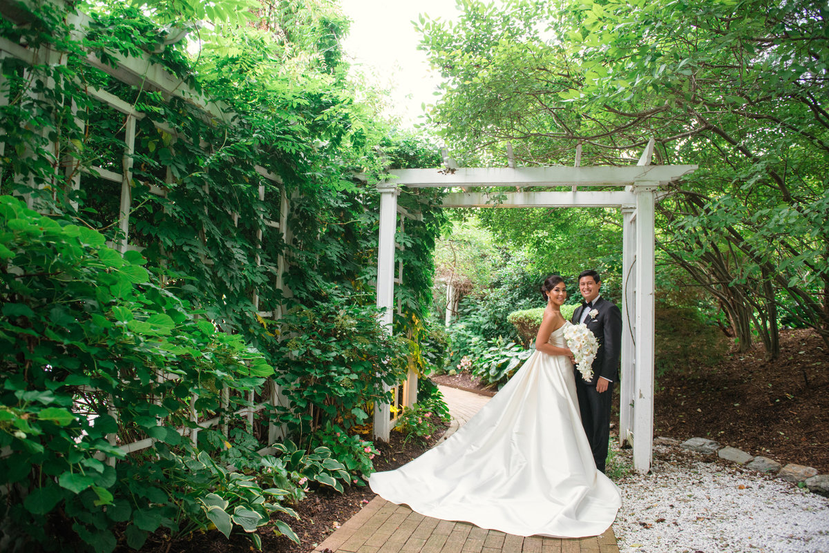 photo of bride and groom in the outdoors gardens for wedding reception at The Garden City Hotel