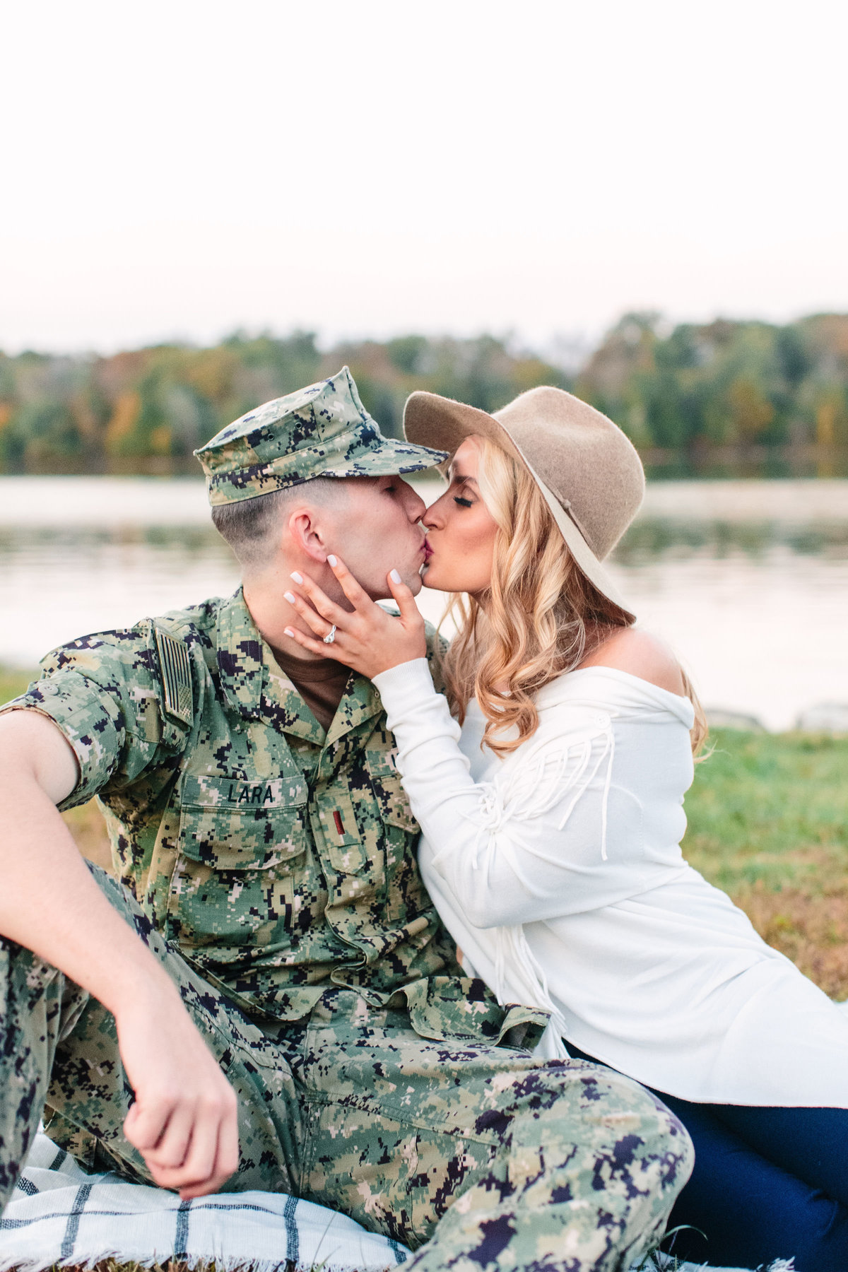 couple kissing by waterfront at wedding venue