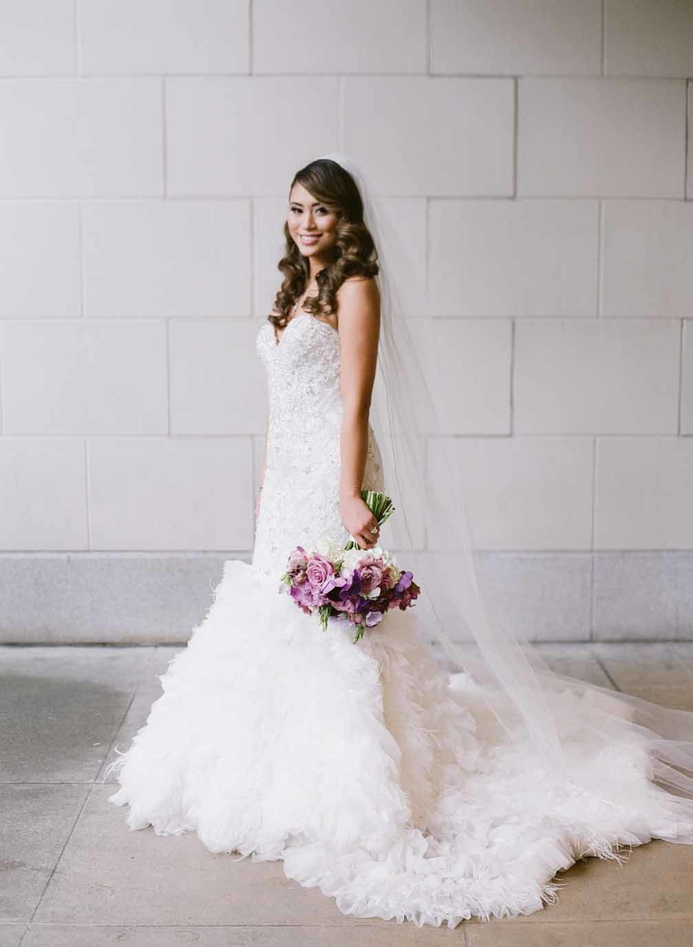 Beautiful bride with purple wedding bouquet