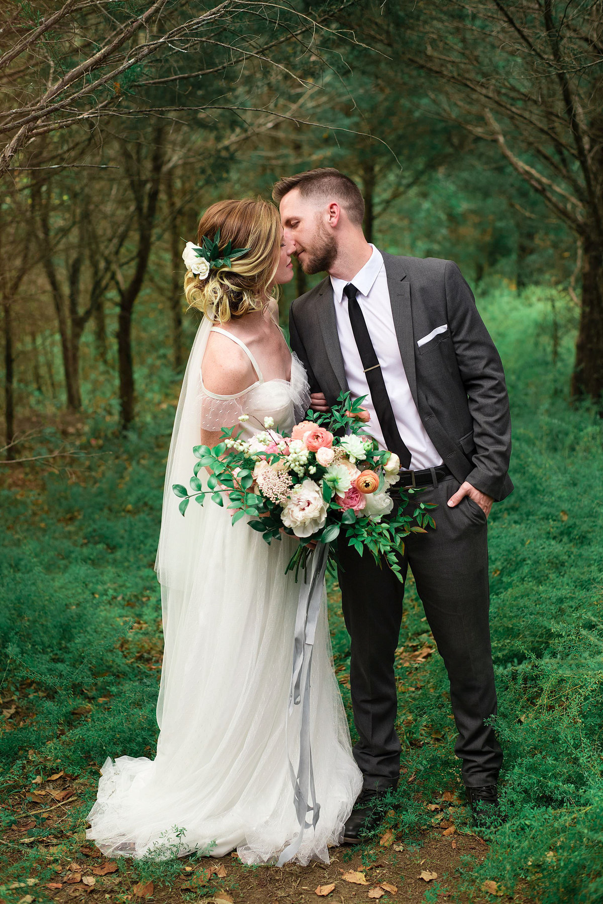 Couple standing in forrest at Cedarwood Wedings