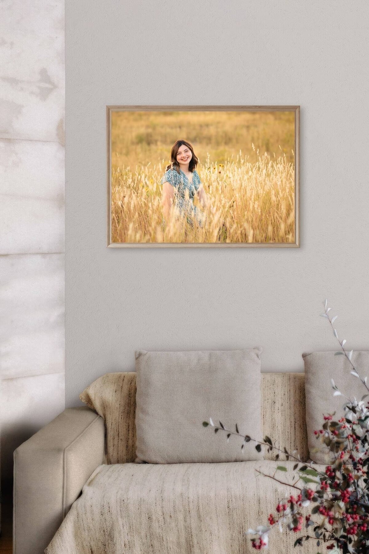 framed picture  of a high school senior girl in a field in Pueblo, CO  hanging above a living room  couch