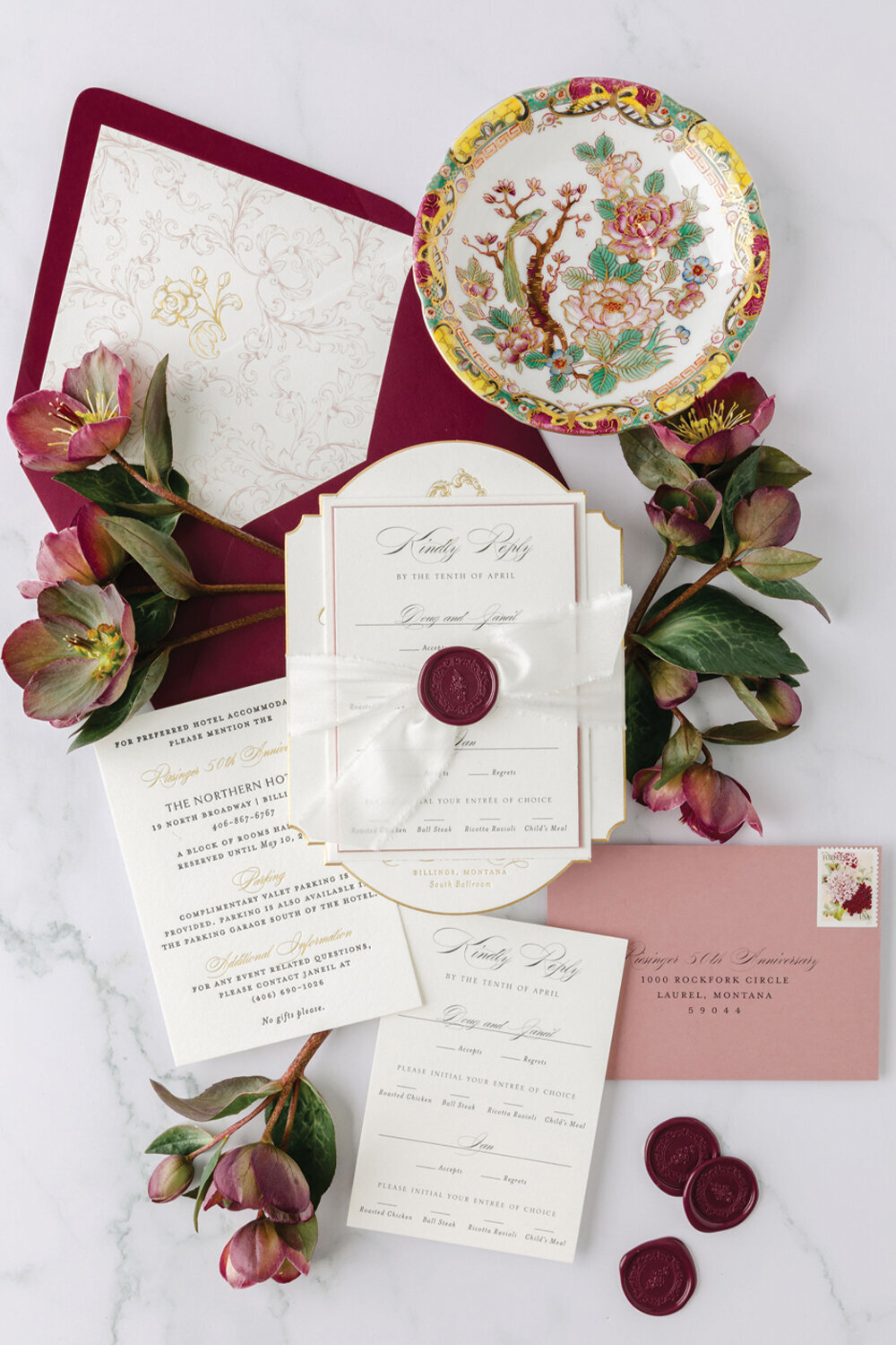Luxurious 50th anniversary invitation suite featuring gold foil lettering, beveled gold edges, and wax seals, designed in shades of burgundy and dusty rose. This refined stationery set captures the timeless sophistication of a milestone celebration at The Northern Hotel in Billings, MT