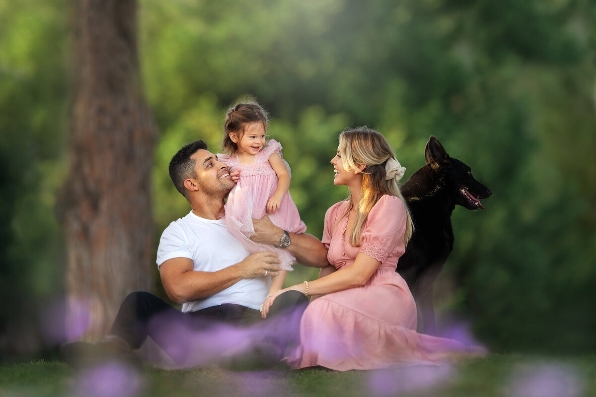 Wilmer  holding his daughter for lifestyle  picture of family with dog