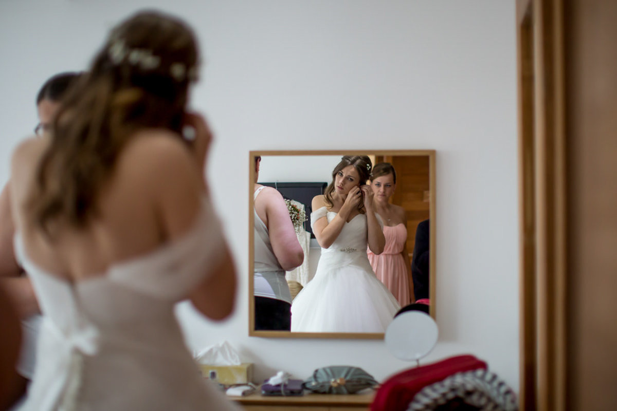 Bridal prep Bride in Mirror at Bath House Tunnels Beaches Devon