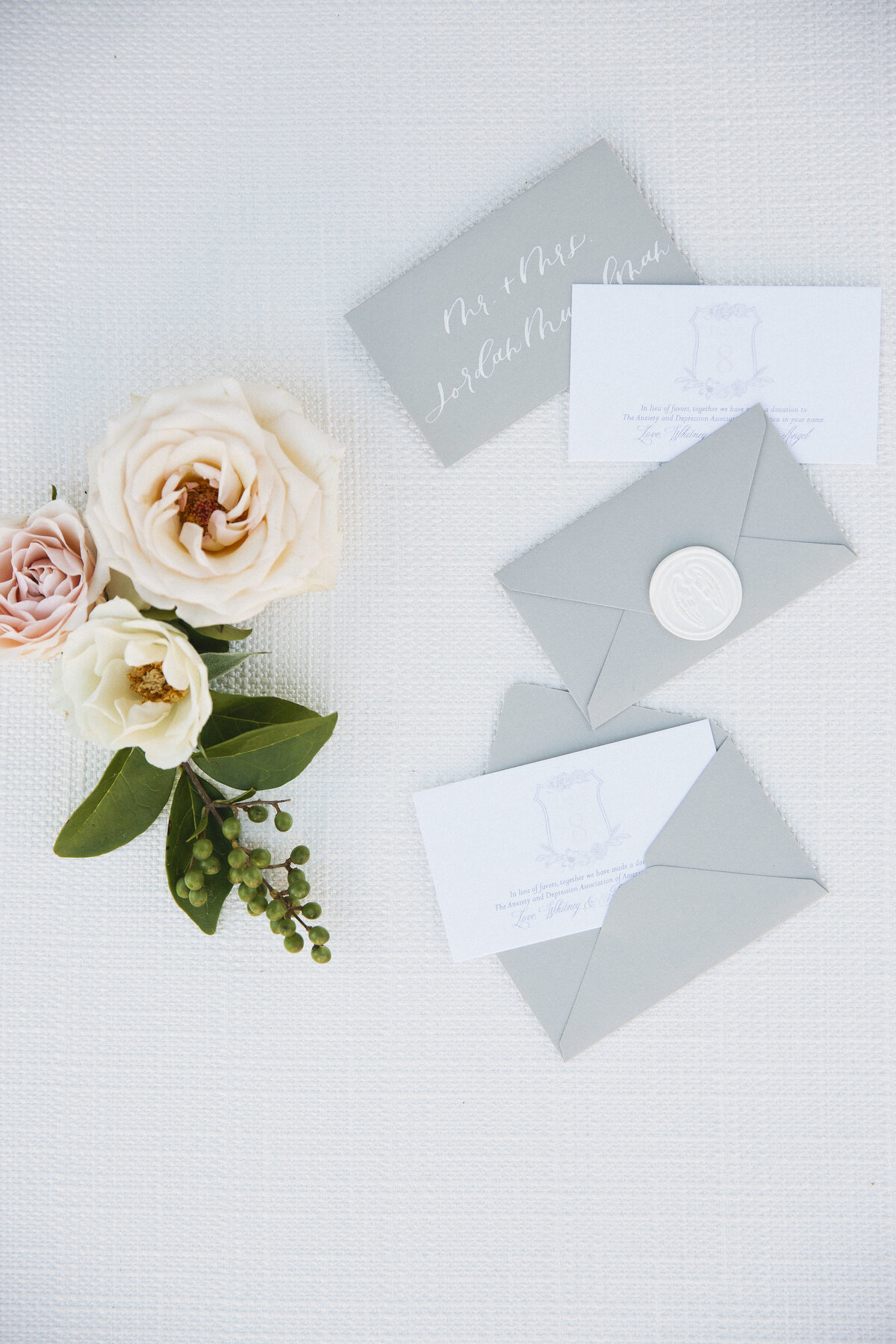 Escort cards with envelopes and wax seals for an escort card display