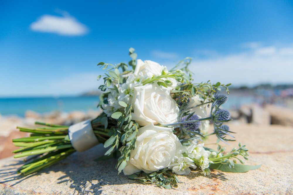 Wedding bouquet on the rocks oceanside on a wedding day at Union Bluff Meeting House York Beach Maine