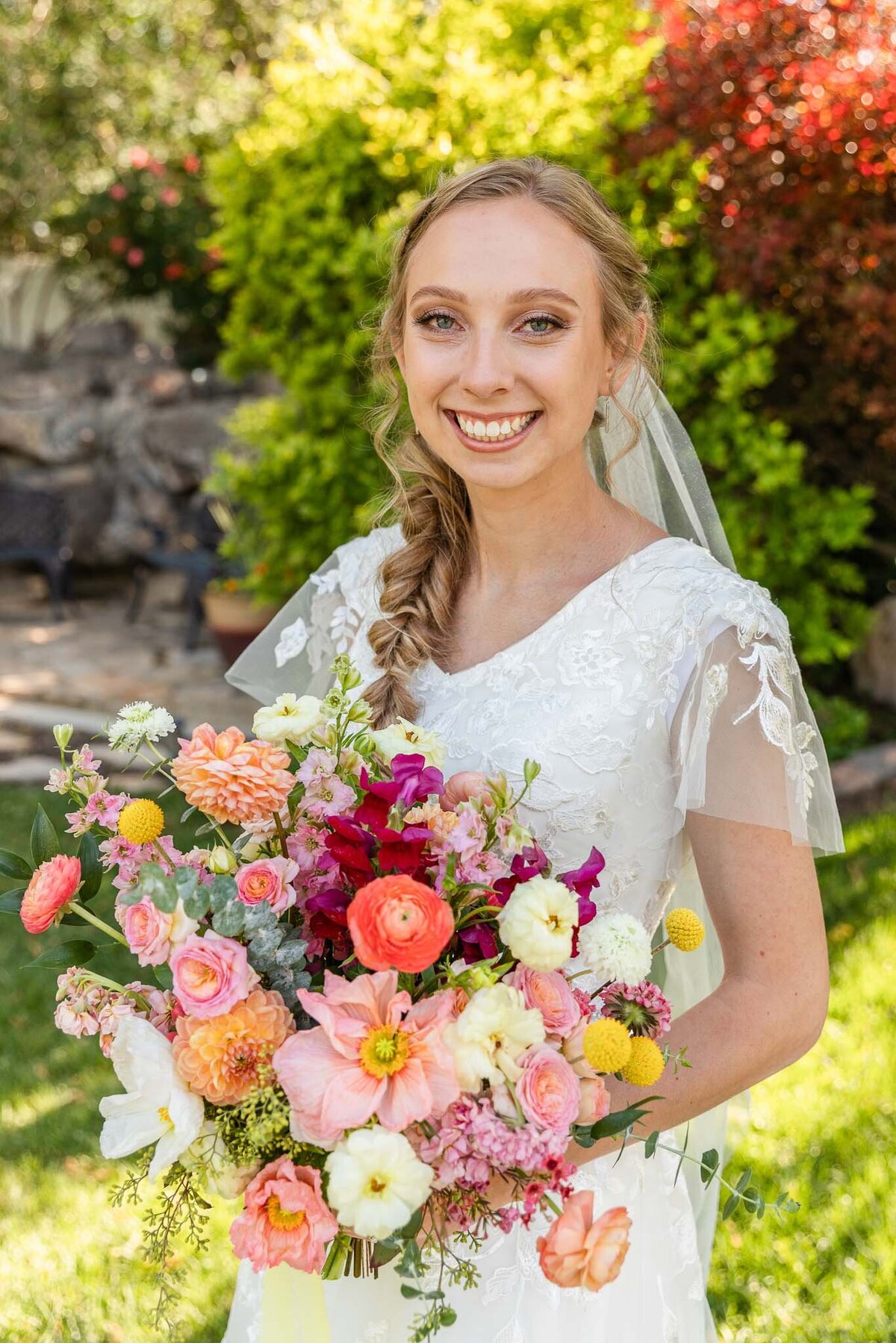 Bride holding colorful bridal bouquet.