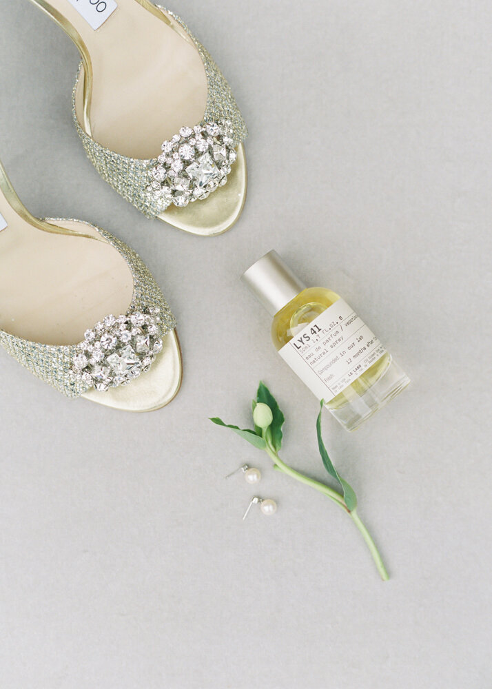 velvet wedding flatly styling board with ivory colour bridal shoes and perfume bottle
