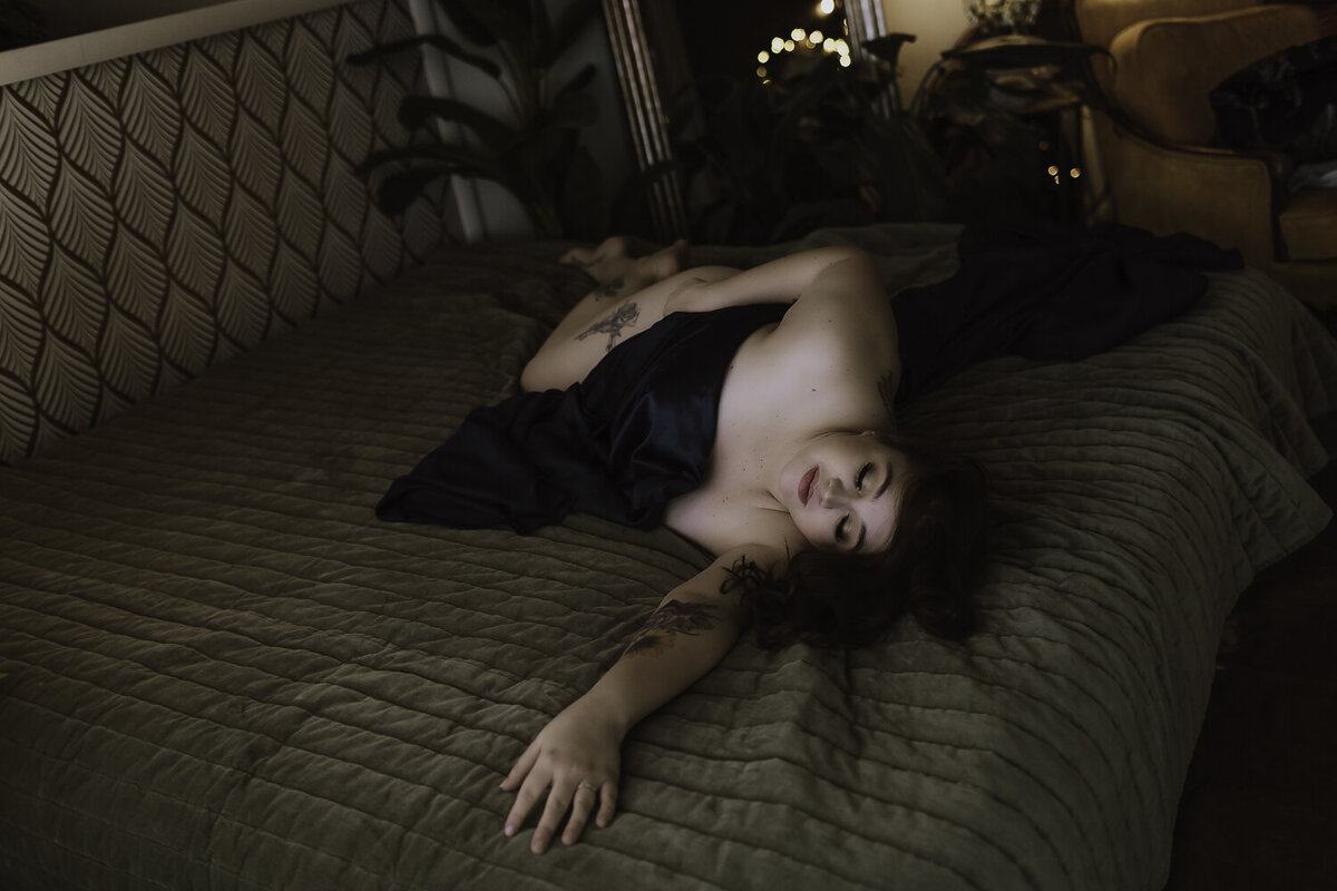 Passionate boudoir session capturing the intimacy of a dark and moody bedroom, where emotions and shadows intertwine.