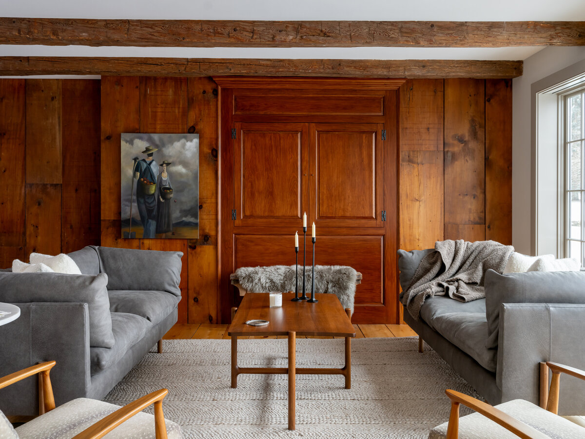 Dark wood living room with art work and furniture