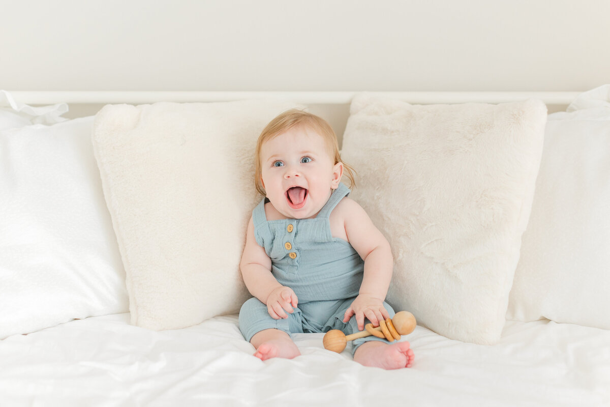 A Baby Photography photo in Northern Virginia of a smiling baby boy on a white bed