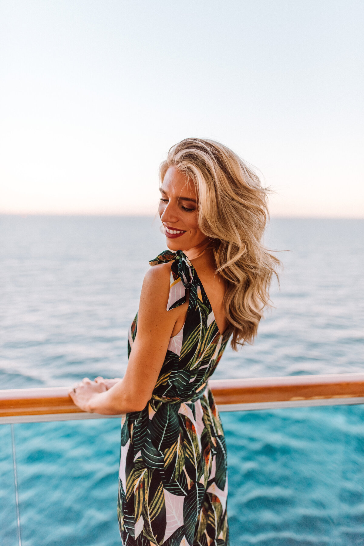 Blonde girl smiling on ocean