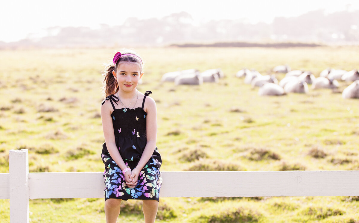 young-girl-on-fence-with-sheep-carmel