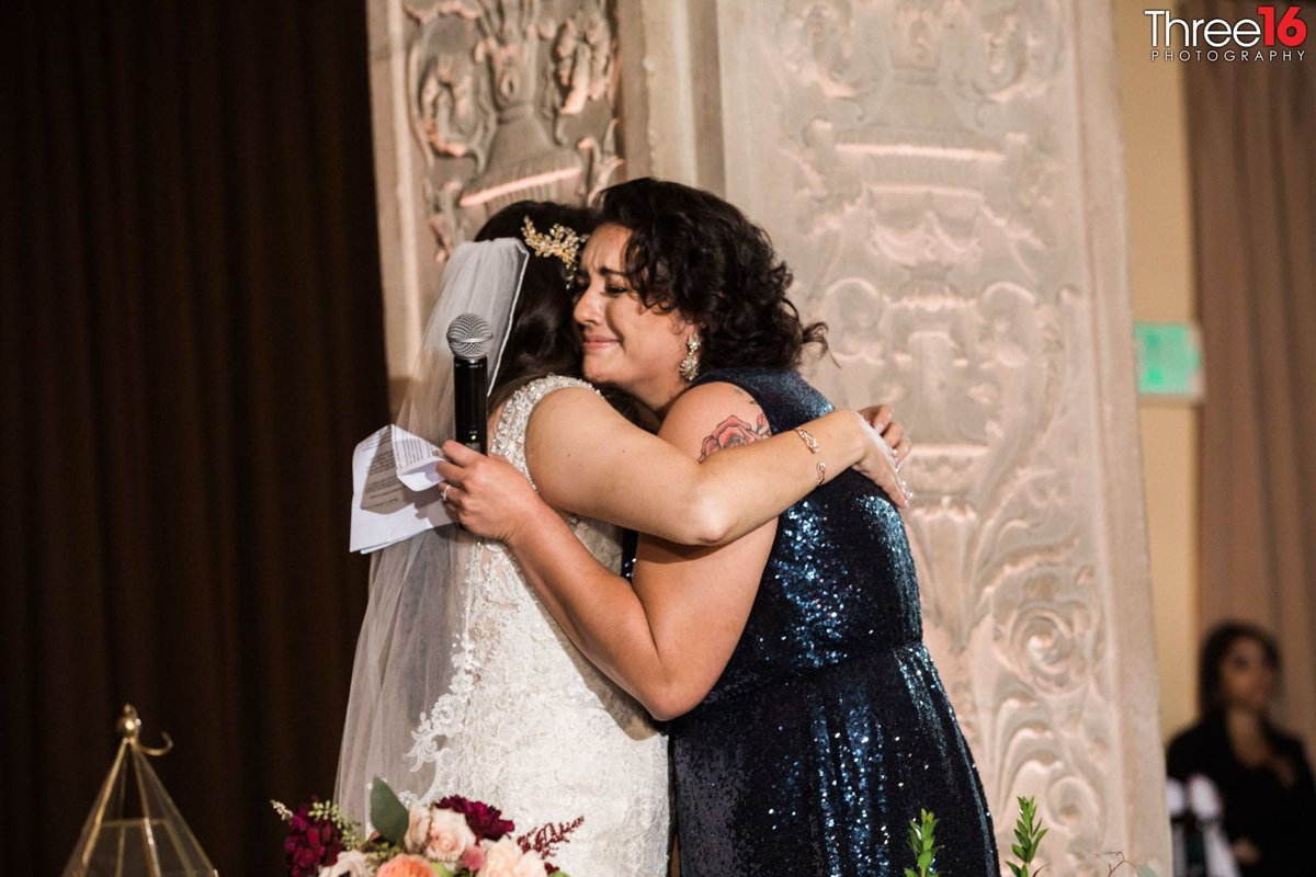 Bride hugs her mother after the toast
