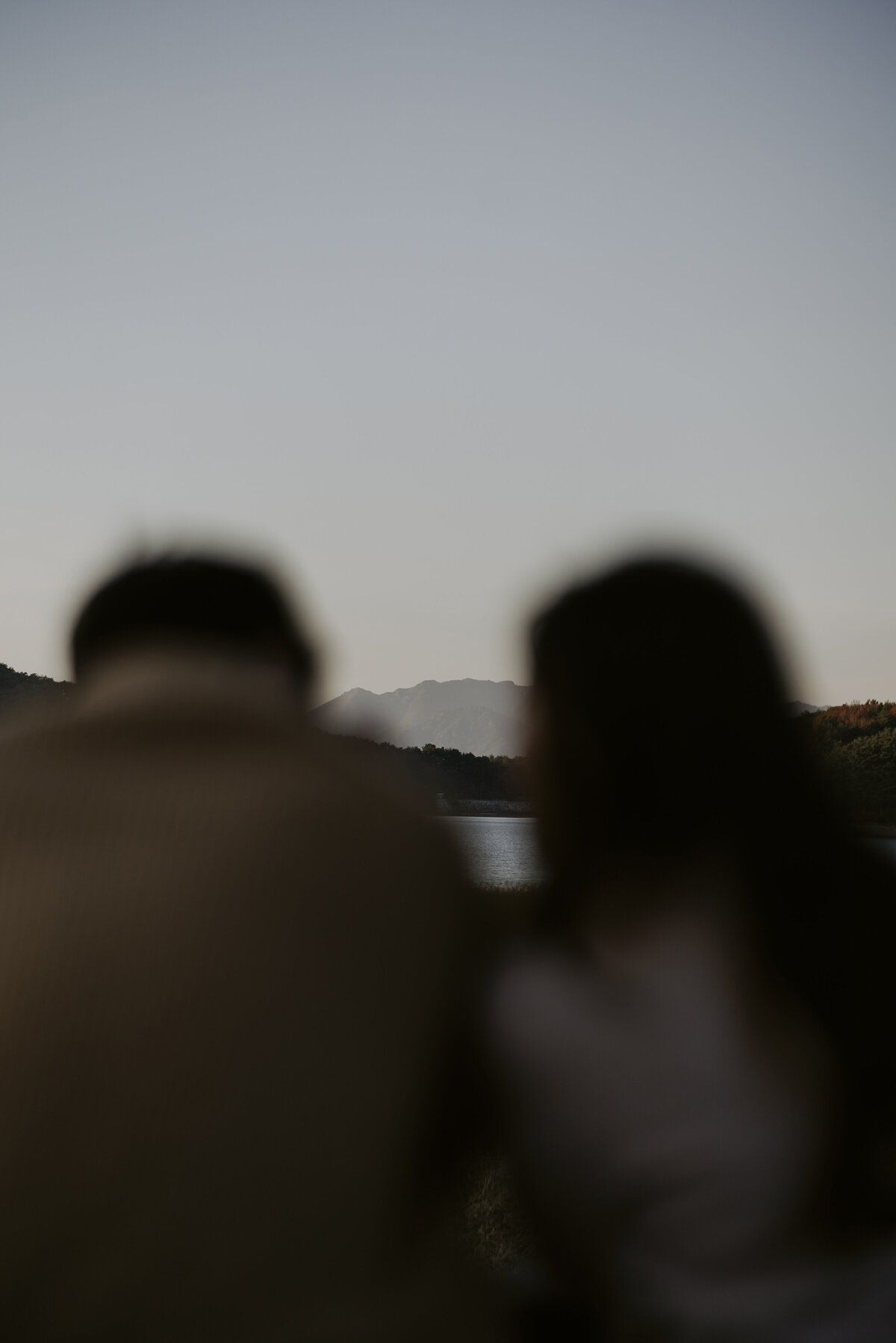 the back of the couple who are looking at the view of the eco park in damyang south korea