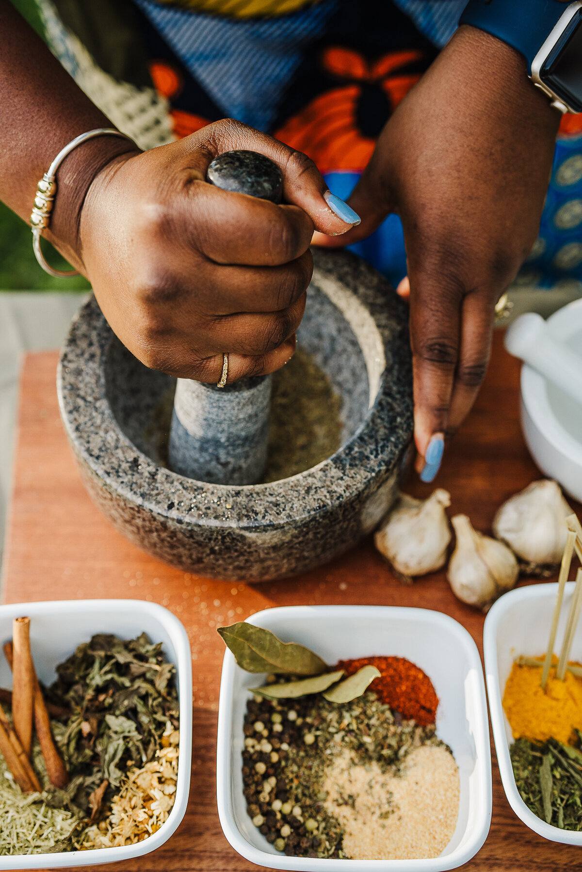 woman grinds herbs with pestel