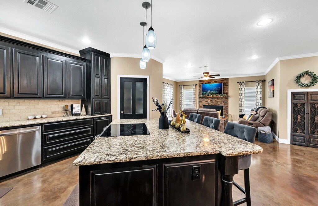 Fully stocked kitchen with island seating in this four-bedroom, four-bathroom vacation rental home and guest house with free WiFi, fully equipped kitchen, firepit and room for 10 in Waco, TX.