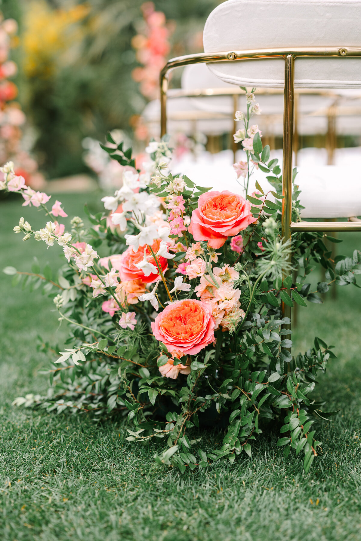 pink florals with lush greenery lining sonoma wedding ceremony chairs.