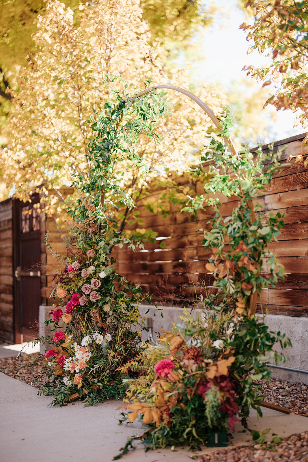Circular wedding arch with bright florals for Longmont colorado wedding