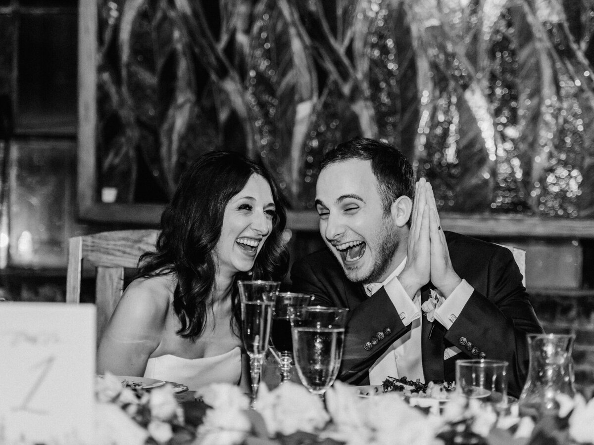 Laughter between newlyweds during a wedding speech in Chicago