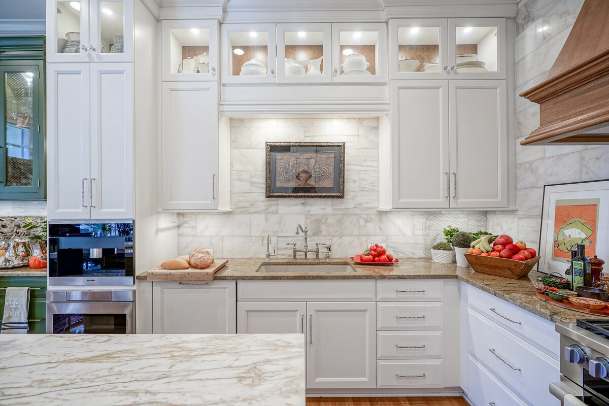white kitchen cabinets above kitchen sink
