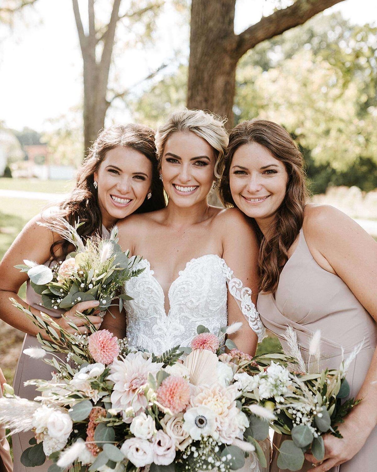 Natalie Brown wedding - bride smiling with bridesmaids