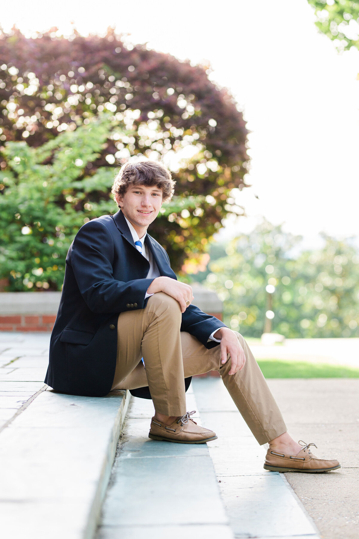 high school senior boy sitting on the steps at McCallie School chapel