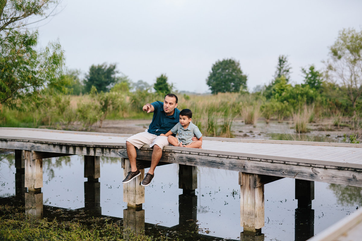 father and son on pier for portrait session by San Antonio photographer Expose The Heart