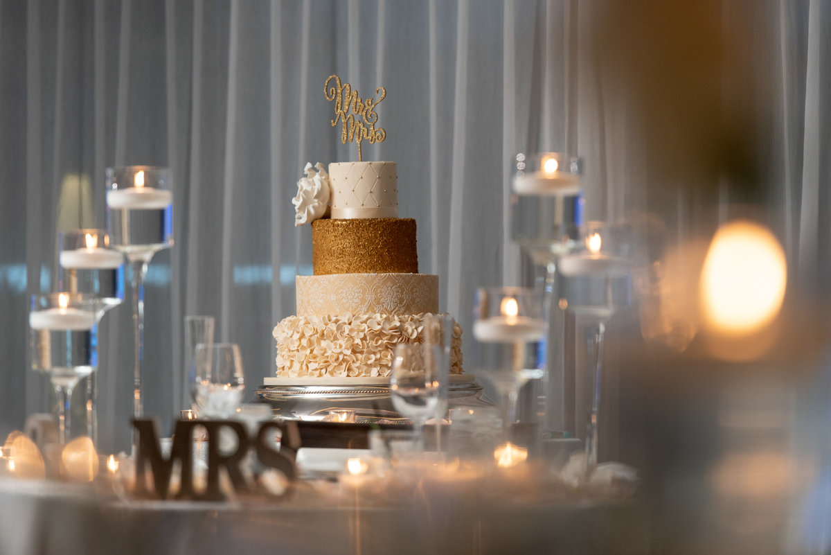 Gold and white wedding cake at Harbor Club at Prime