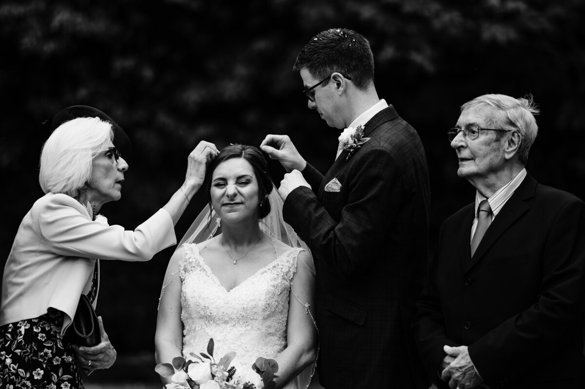groom picking confetti out of brides hair