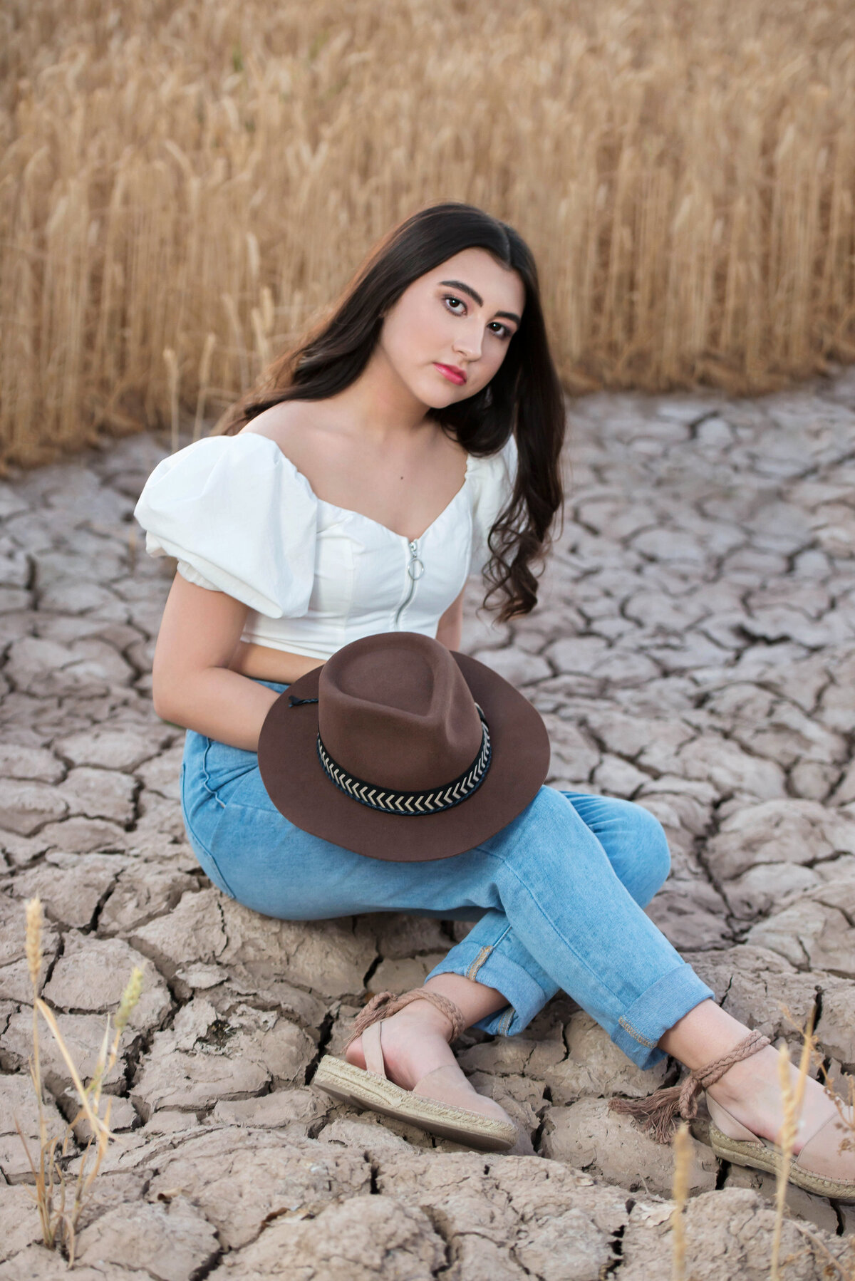 senior with hat in dirt