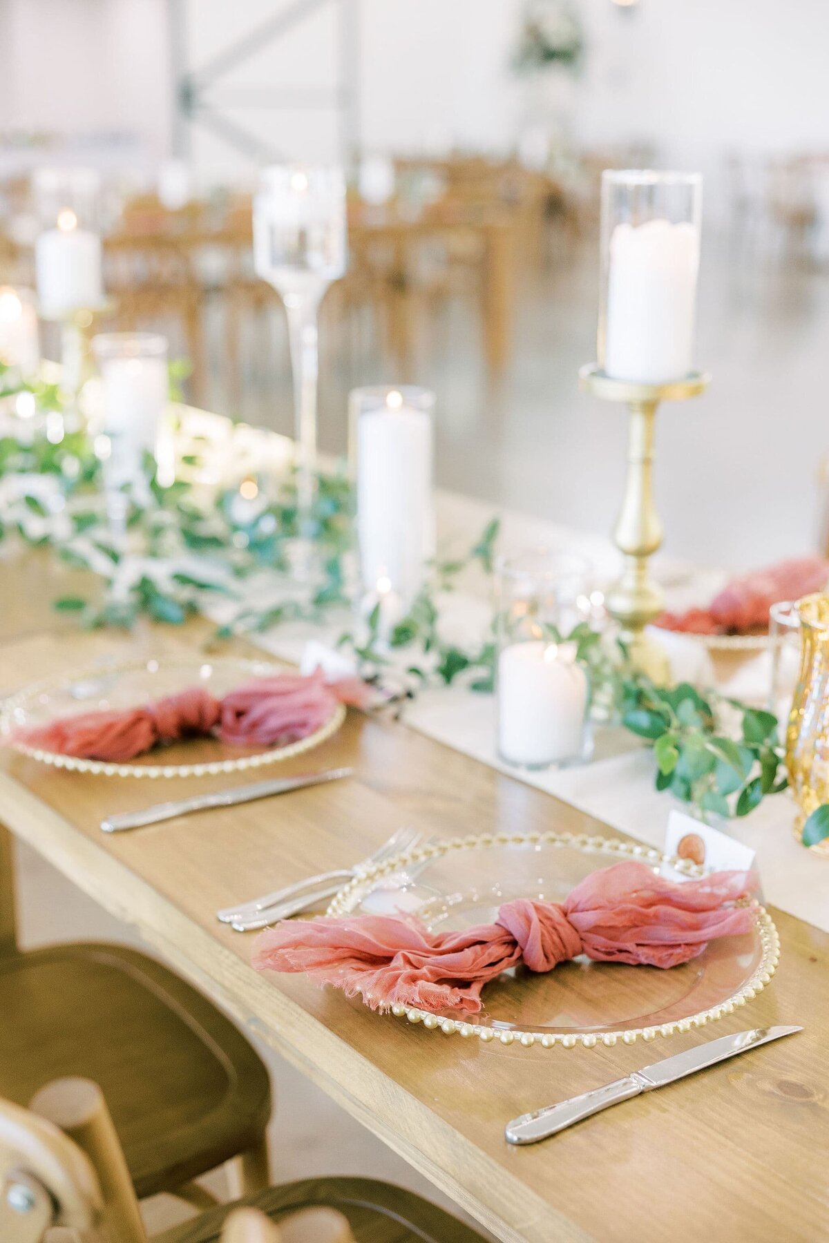 boho wedding table setting with pink linen and natural wood