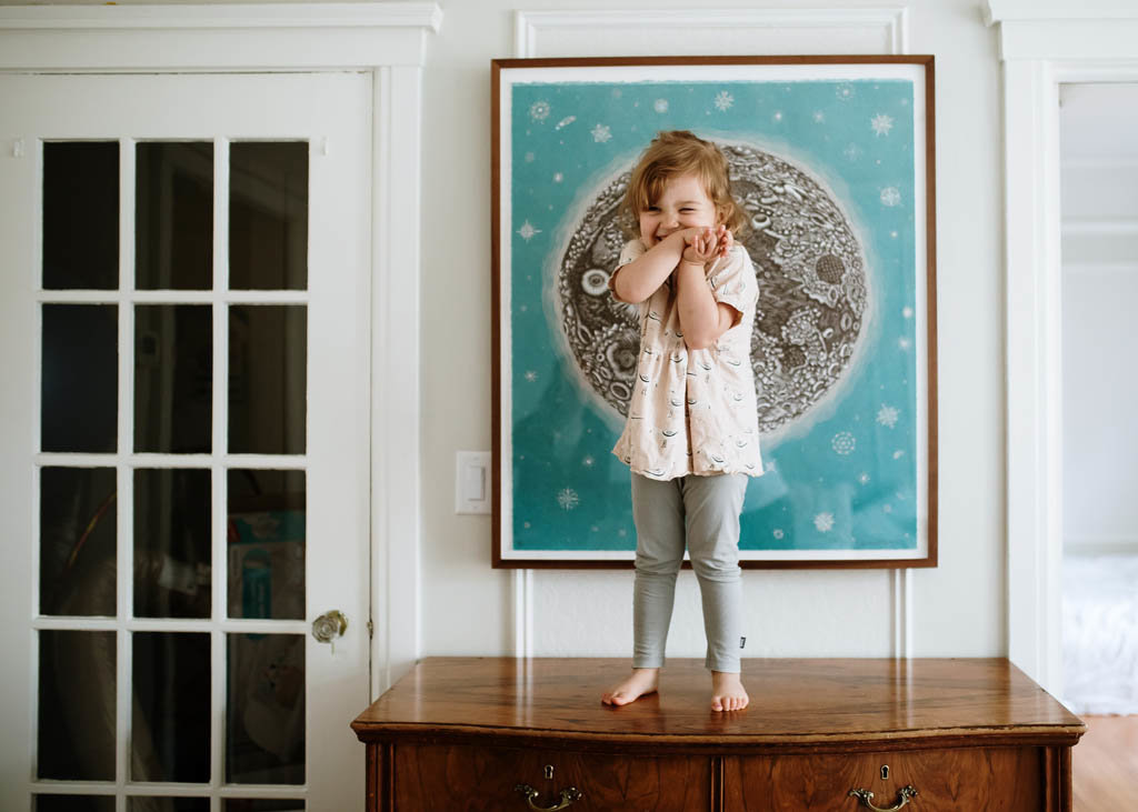Bay Area in home family photography candid child portrait standing  on dresser and smirking