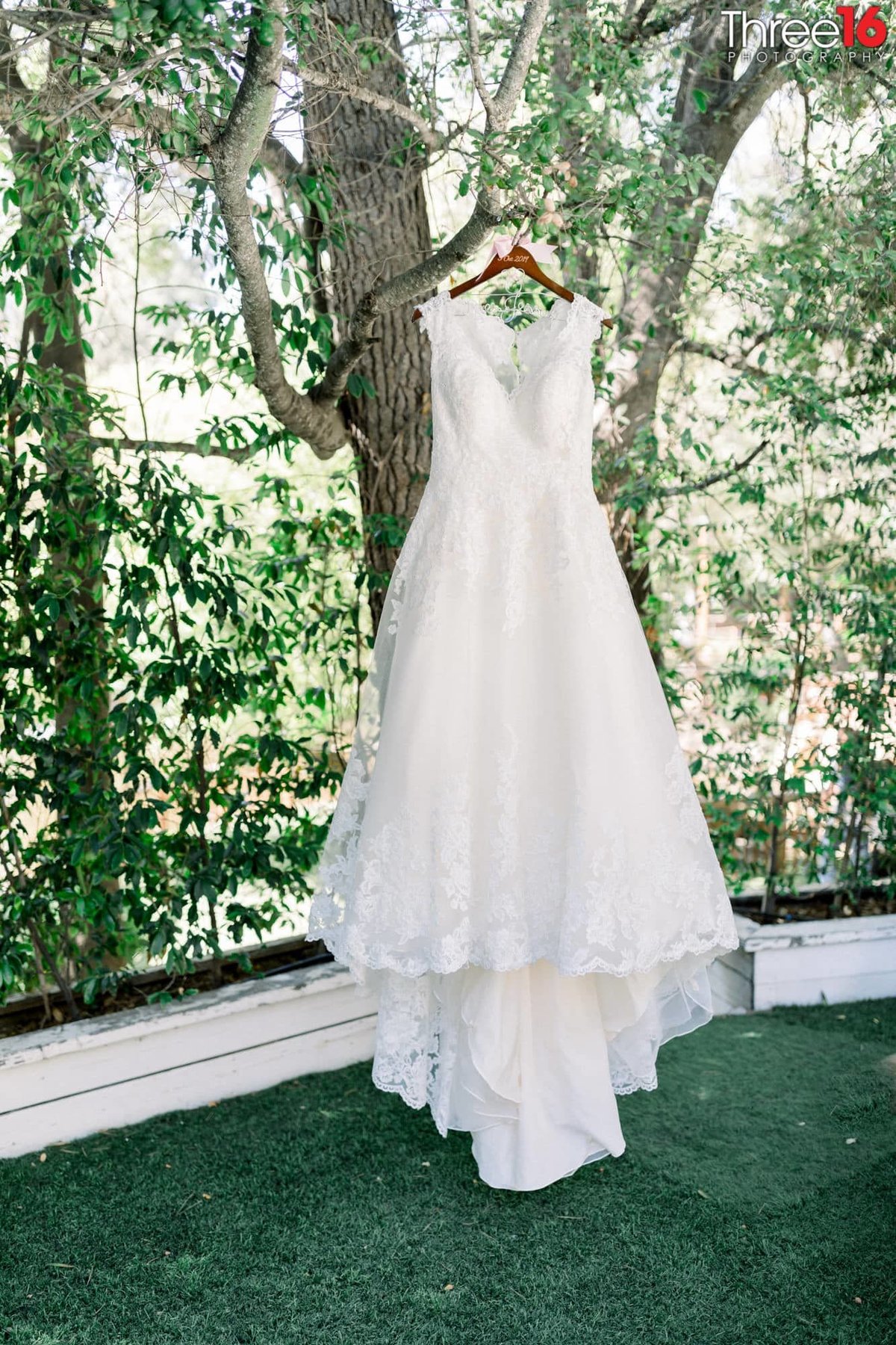 Wedding gown hanging from a tree at Calamigos Ranch in Malibu, CA