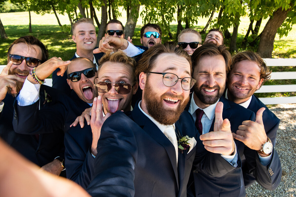 Groom does a selfie with his groomsmen.