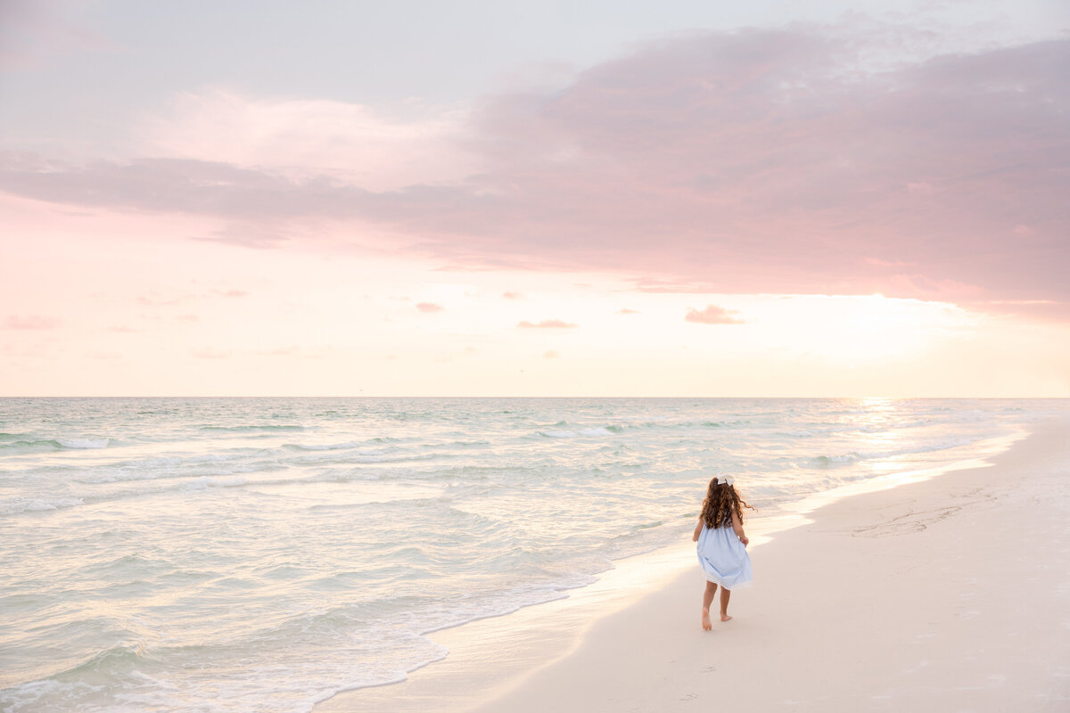 A small child walking along the beach