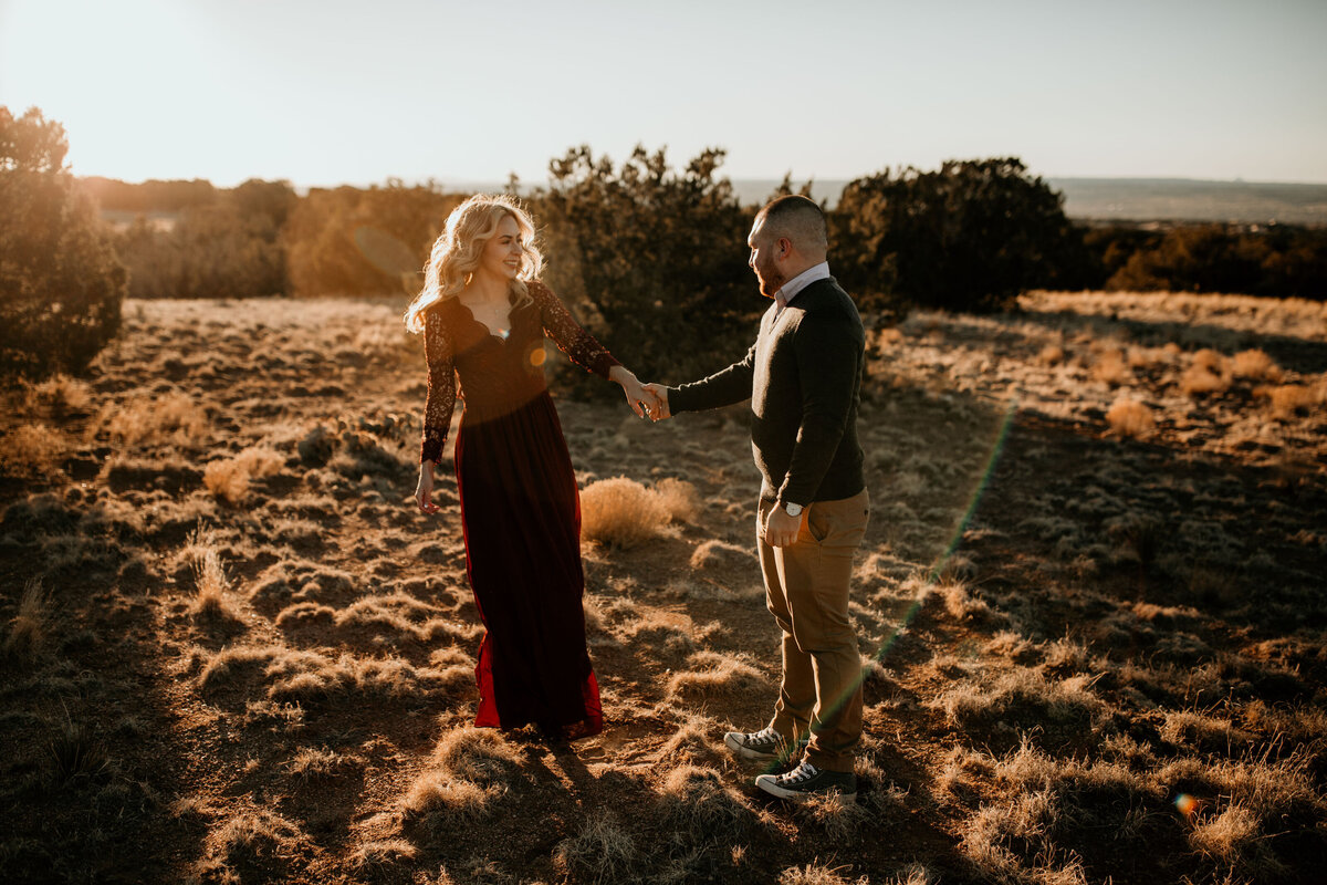 engaged couple dancing in the desert